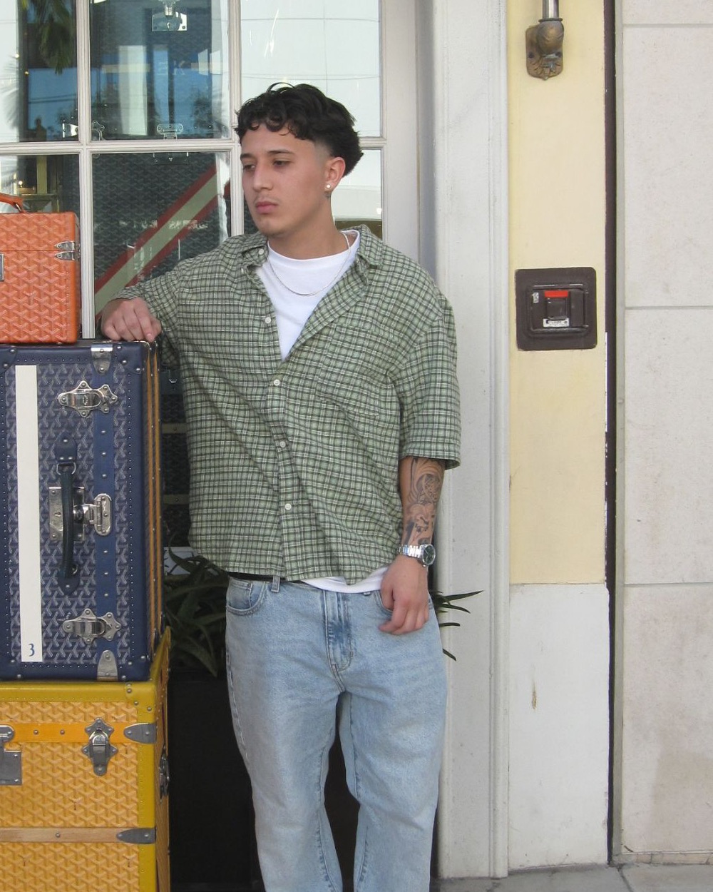 Ace, barber in Metairie, Louisiana, outside the shop on 18th Street